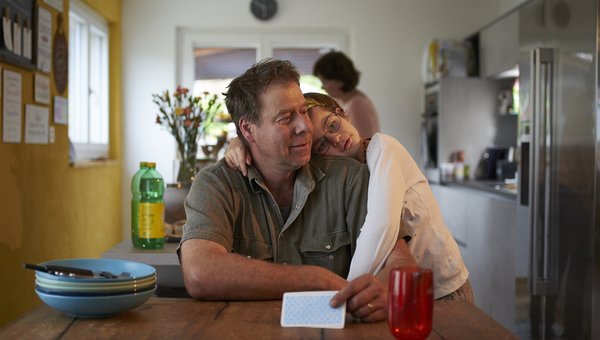 Hanna repose sa tete sur l'épaule de son père.